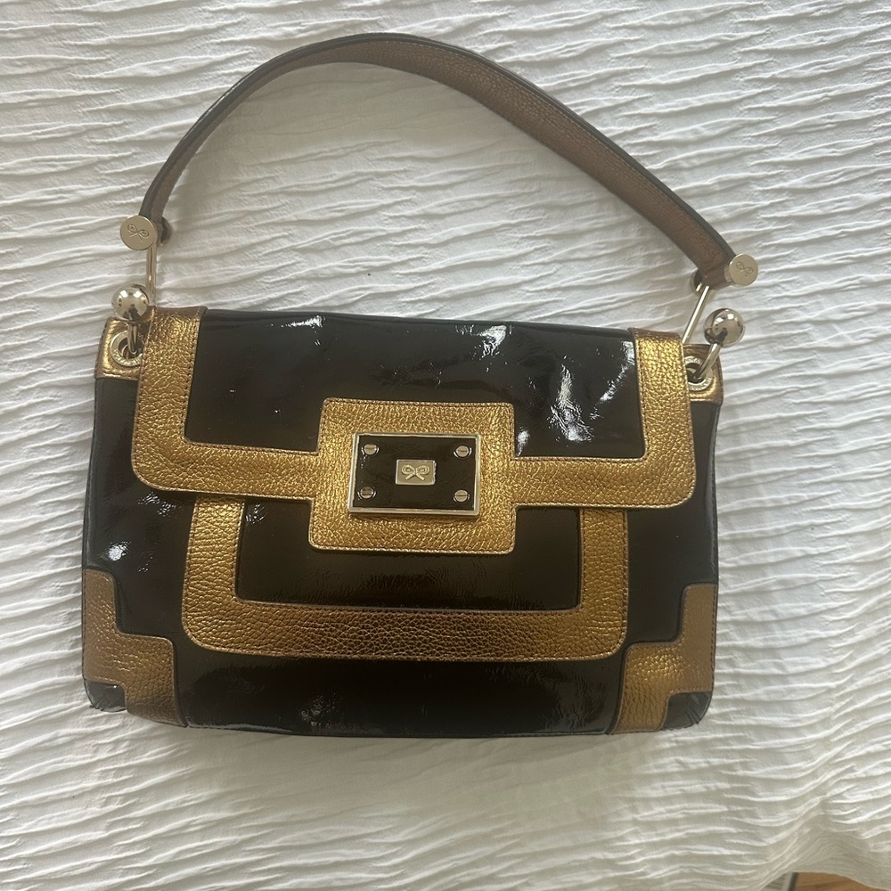 Anya Hindmarch black patent leather and gold bag